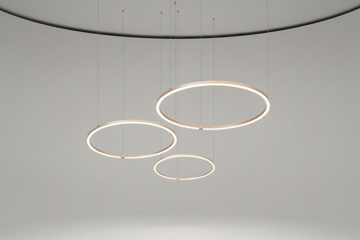Set of three circular pendant lights on a white background