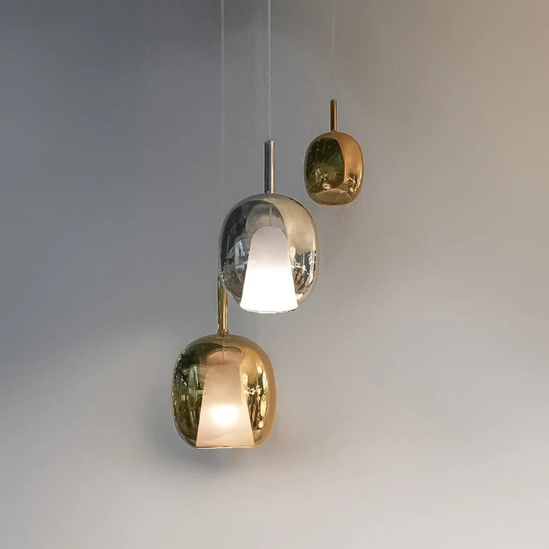 Modern pendant light with gold and silver design on a neutral background