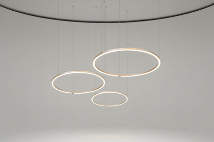 Set of three circular pendant lights on a white background