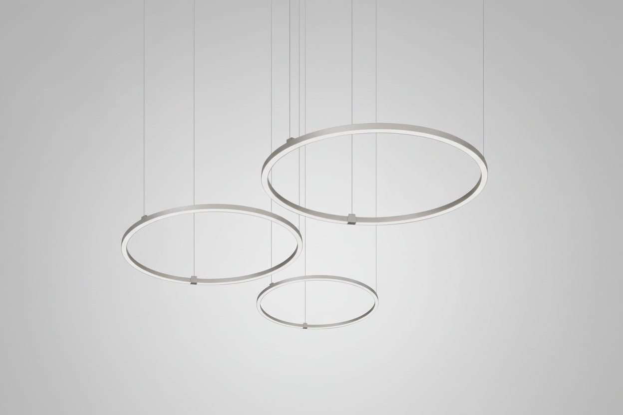 Modern pendant light with three circular metal shades on a white background