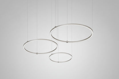 Modern pendant light with three circular metal shades on a white background