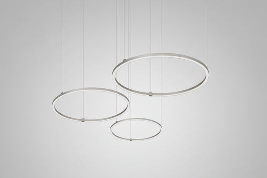 Modern pendant light with three circular metal shades on a white background